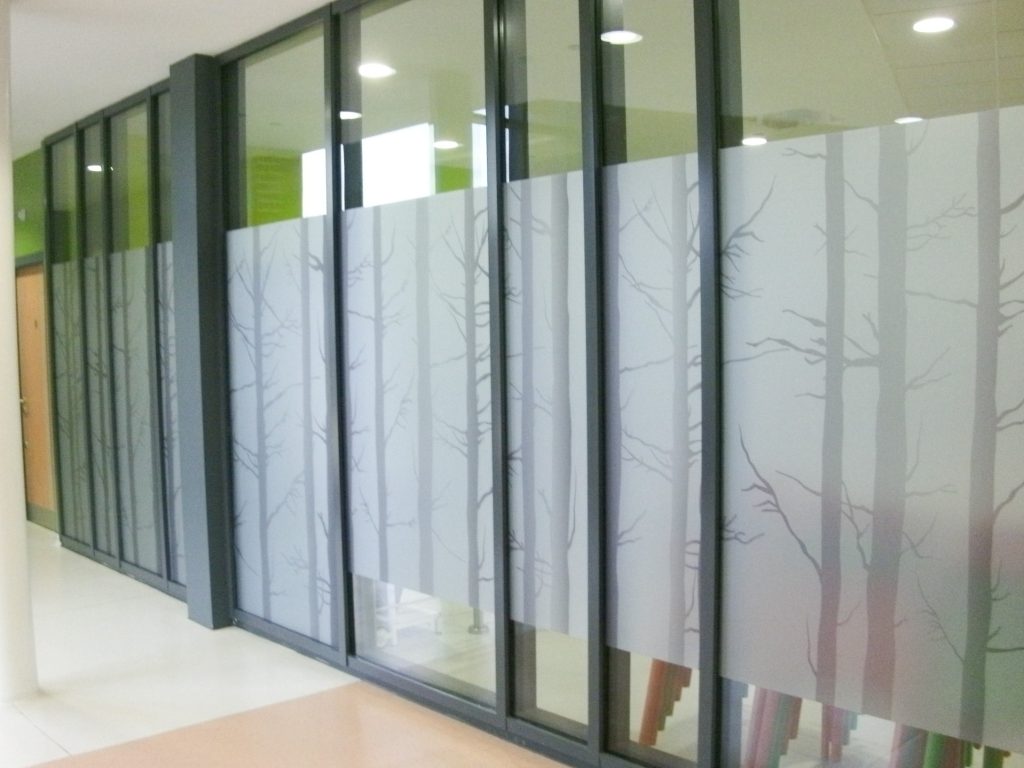 Frosted privacy window film with tree design etched in.