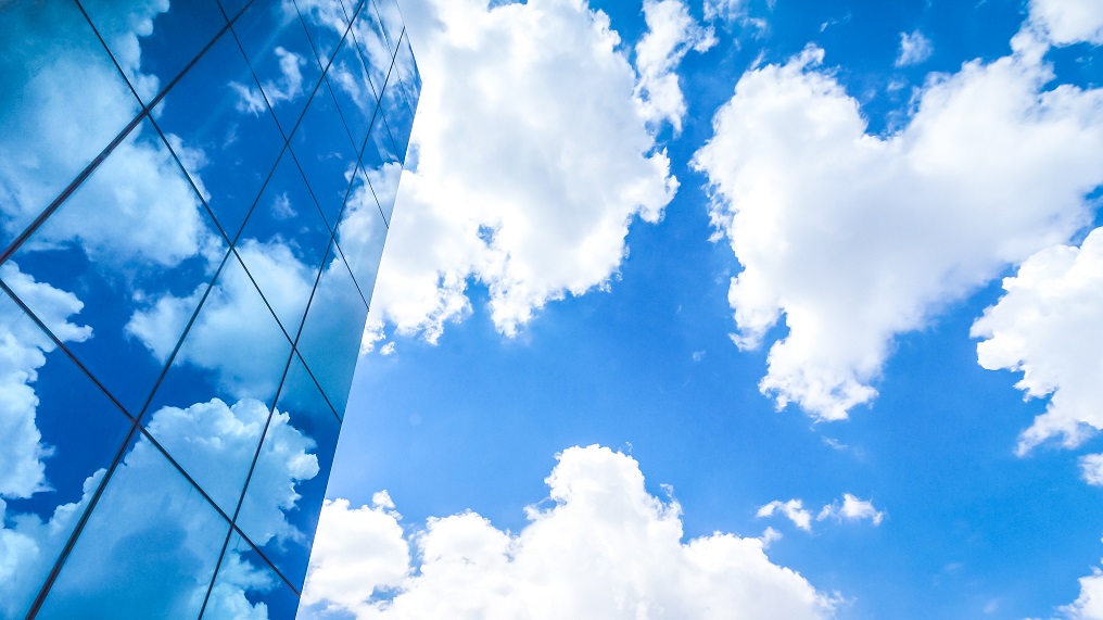 Window Film applied to building glazing panels reflecting clouds