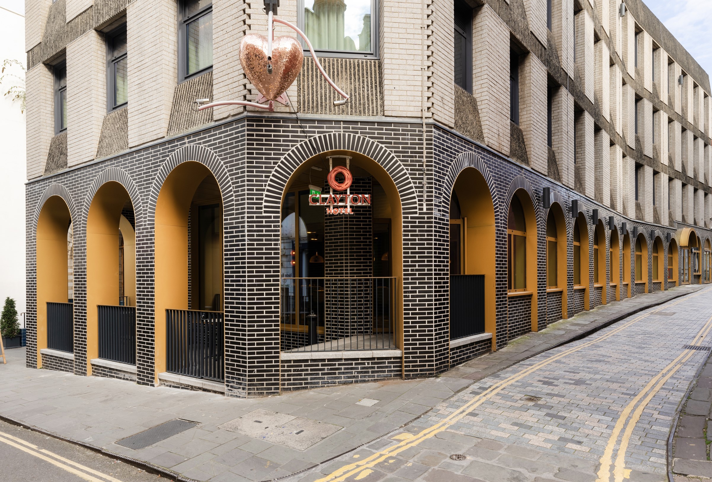 Clayton Hotel Bristol external powder coated text and logo sign fitted under a brick arch
