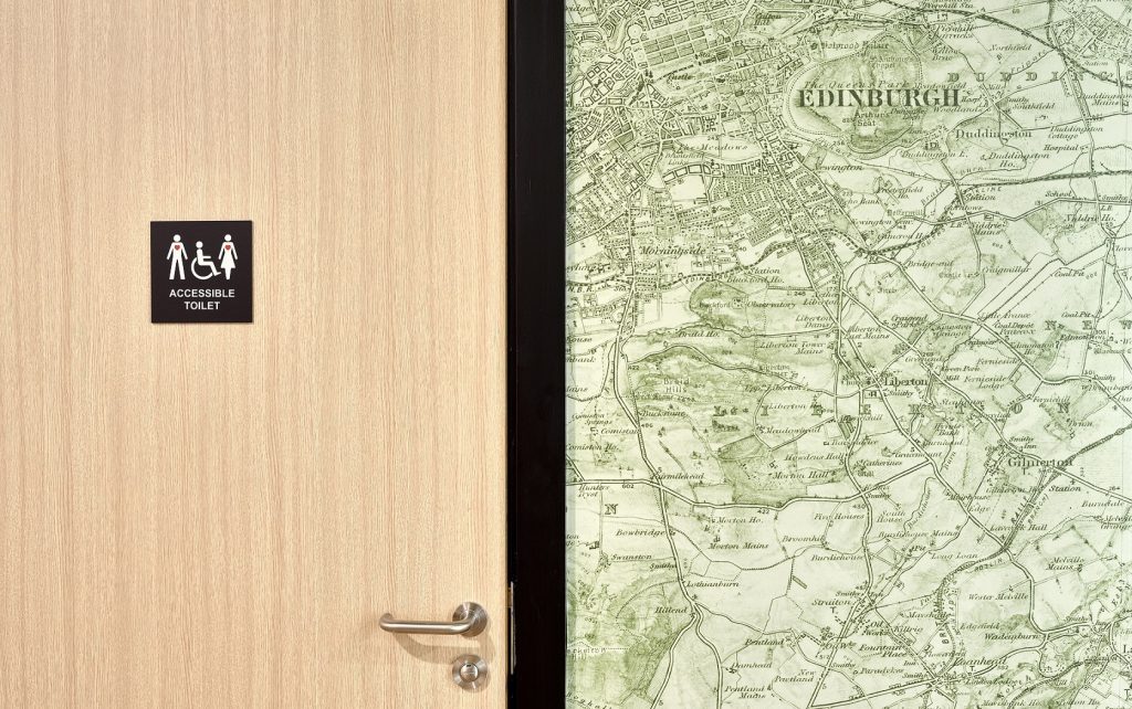 Wallyford Learning Campus, digitally printed wallpaper, map of scotland in shades of green, and accessible toilet door sign
