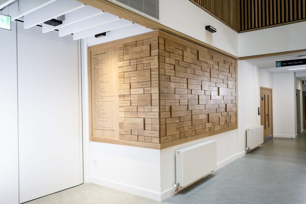 University of Glasgow Clarice Pears Building Donor Wall with Engraved oak tiles fitted around corner of a wall