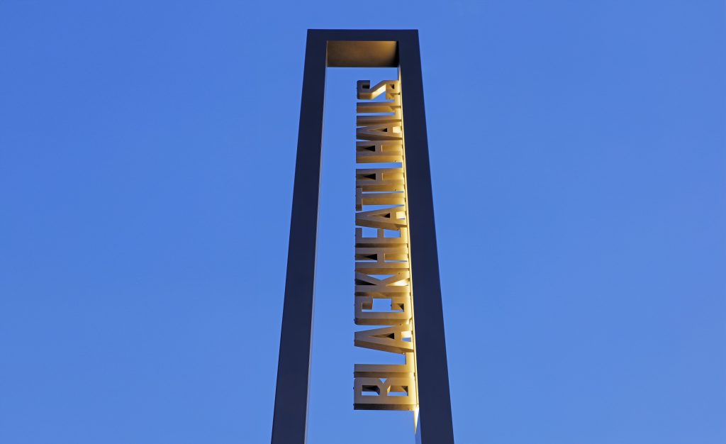Blackheath Halls Built Up Illuminated text in totem frame at dusk