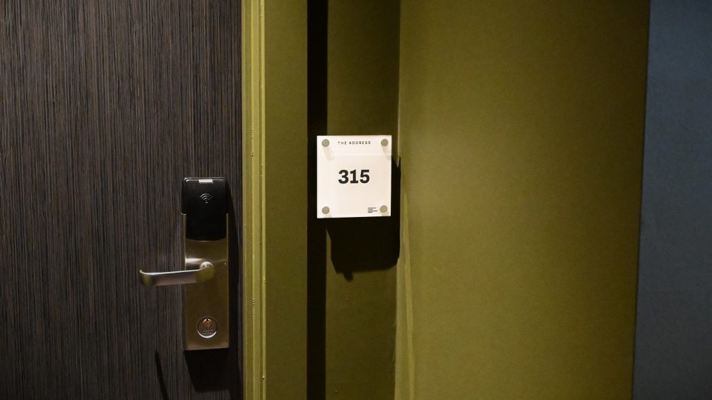 The Address Hotel Signage. Acrylic room number sign fitted on stand off sign fixings / locators outside hotel room door.