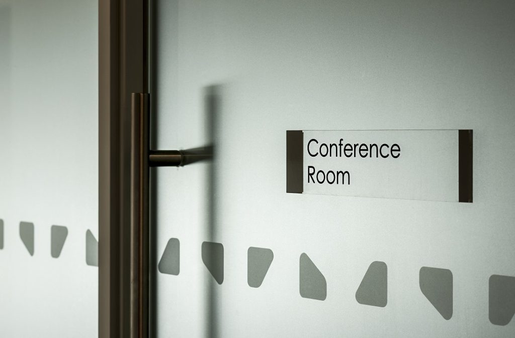 Newmains & St Brigids clear acrylic door sign and manifestation applied to glass panels outside the meeting room