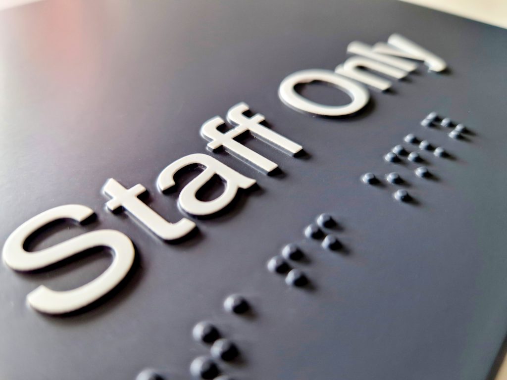 MSS door sign with Braille and Tactile white text that reads Staff Only