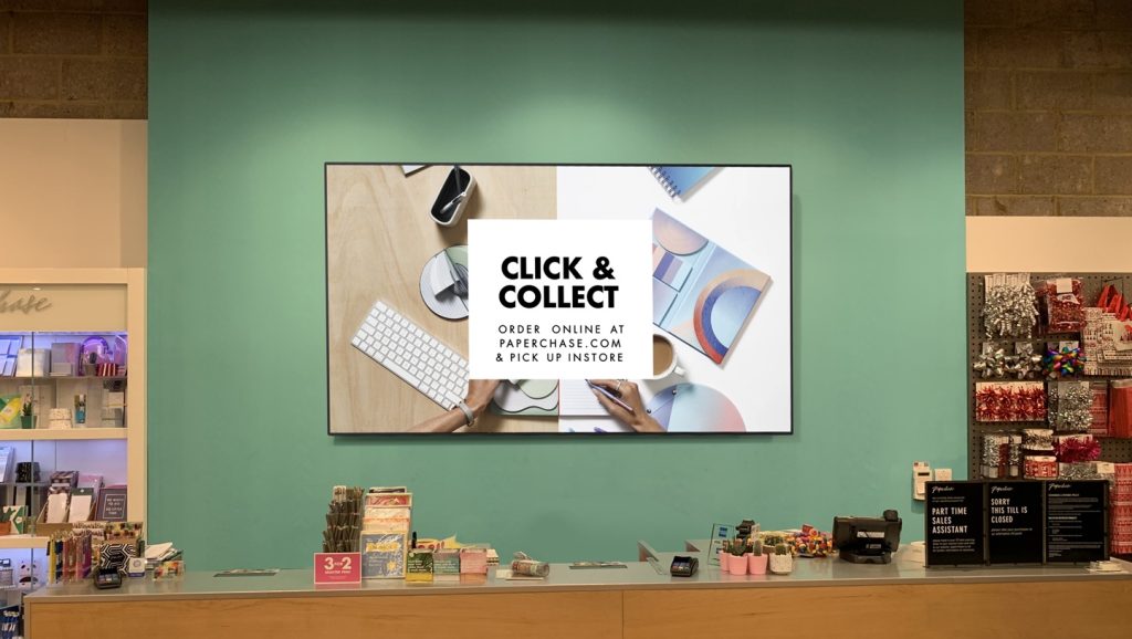 poster mounted to a wall behind the customer service desk in a store