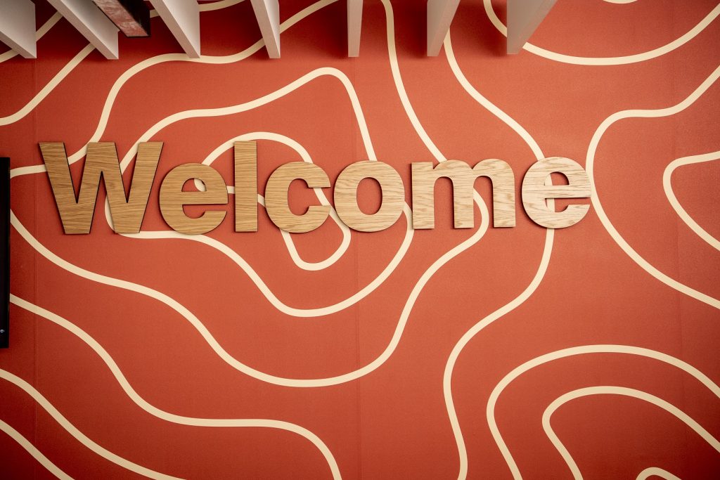 Clarice Pears Building University of Glasgow timber welcome sign fitted to digitally printed wallpaper reception wall