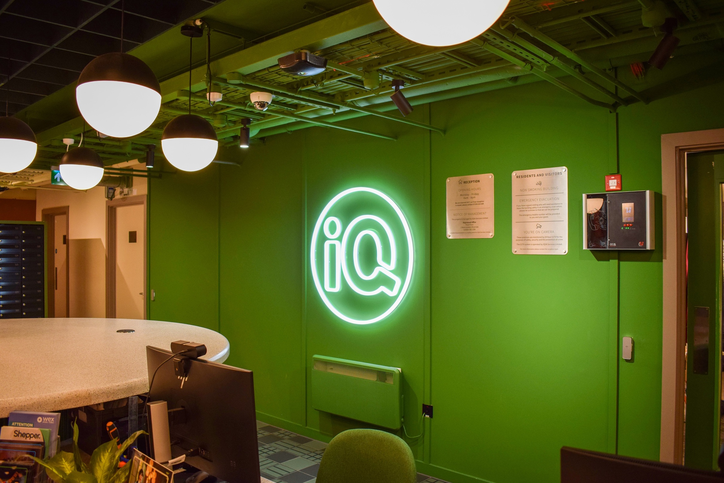 iQSA Cullen House Signage neon iQ logo sign on a painted green wall