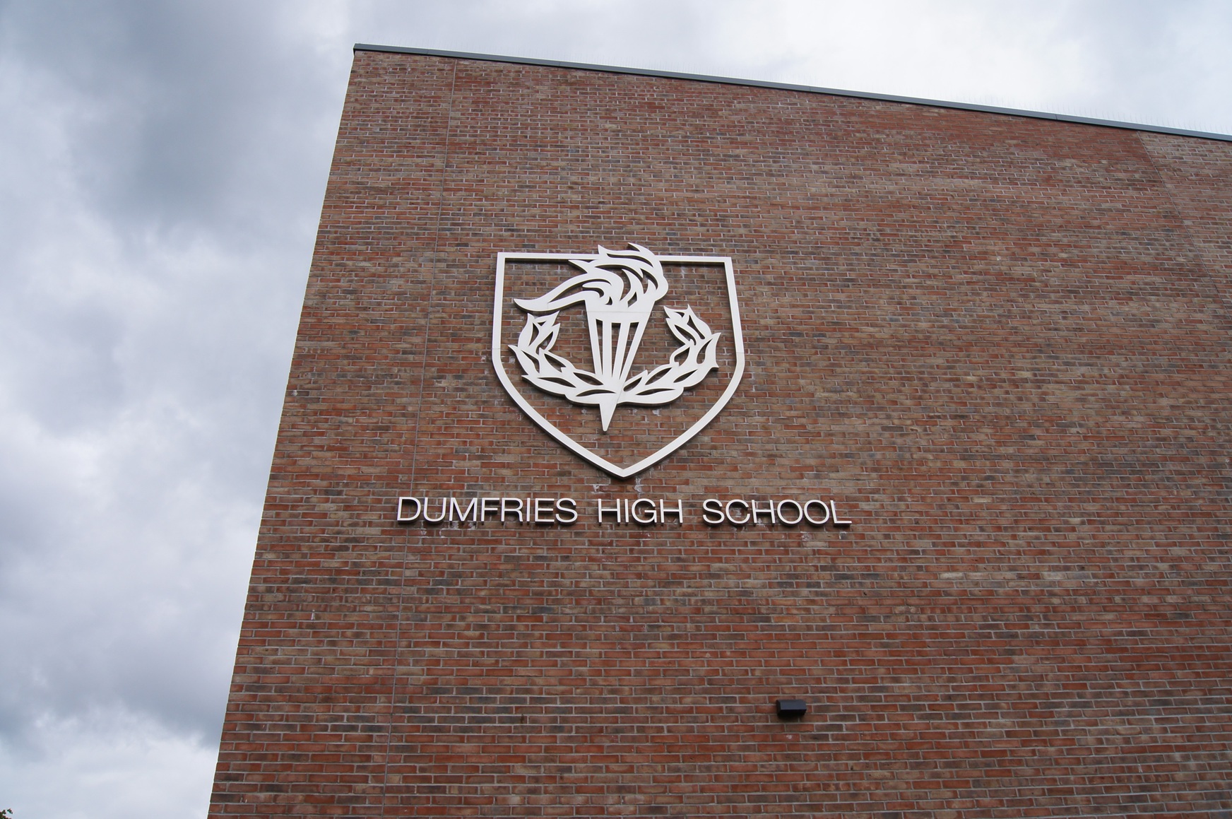 Dumfries High School Built up stainless steel text and crest fitted to brickwork on the building facade