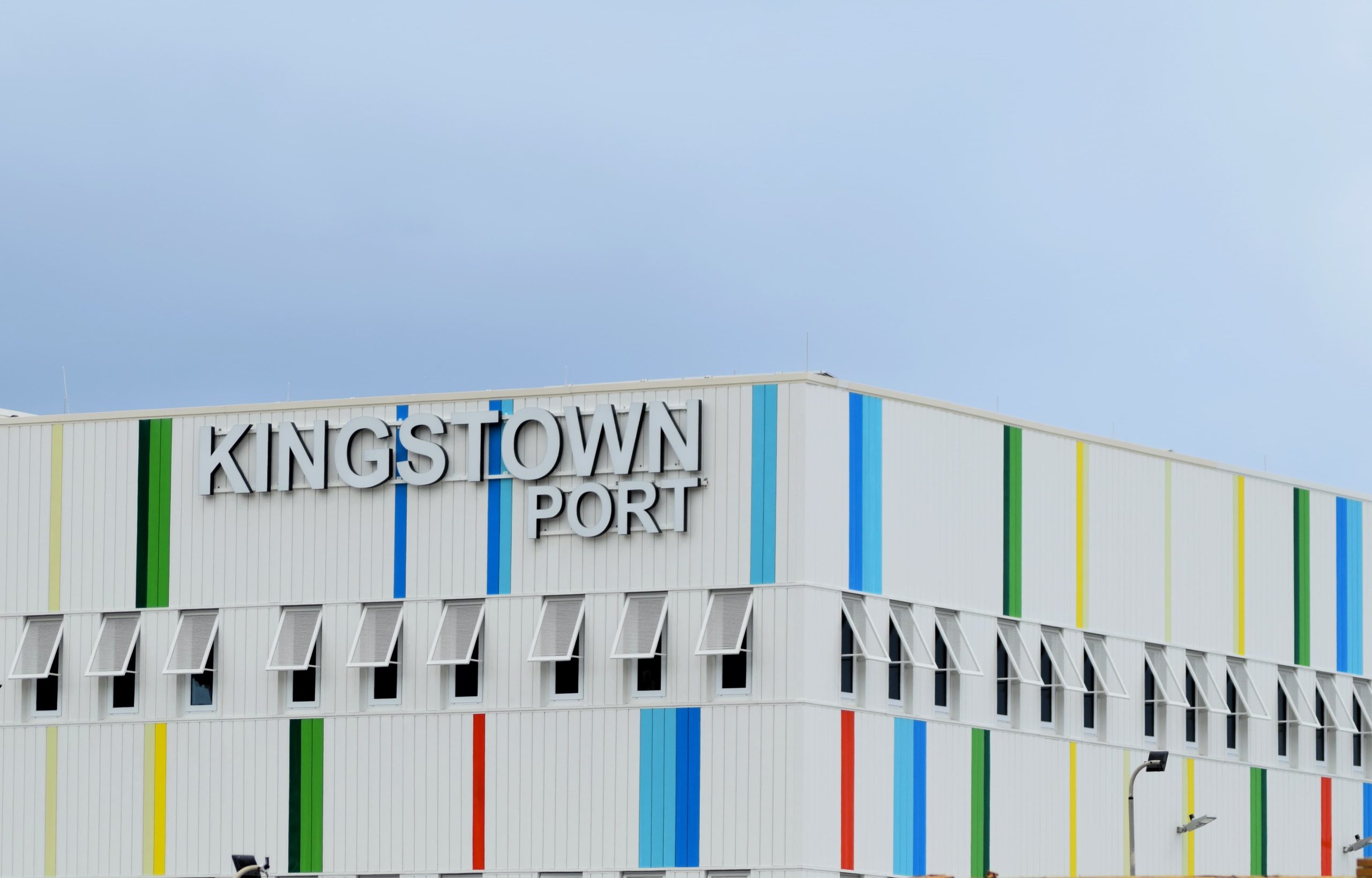 Built up illuminated text fitted to striped coloured cladding at Kingston Port, Jamaica