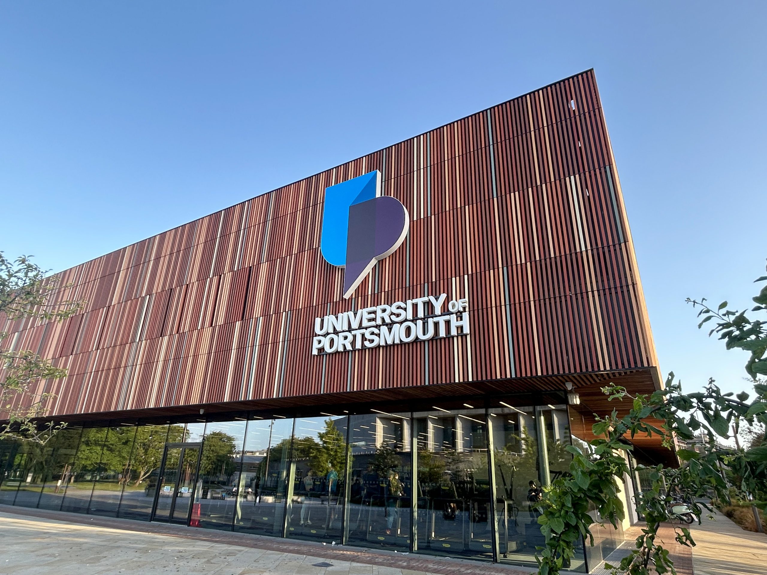 University of Portsmouth Illuminated building text and logo sign. Fitted to the external cladding at Ravelin Sports Centre.